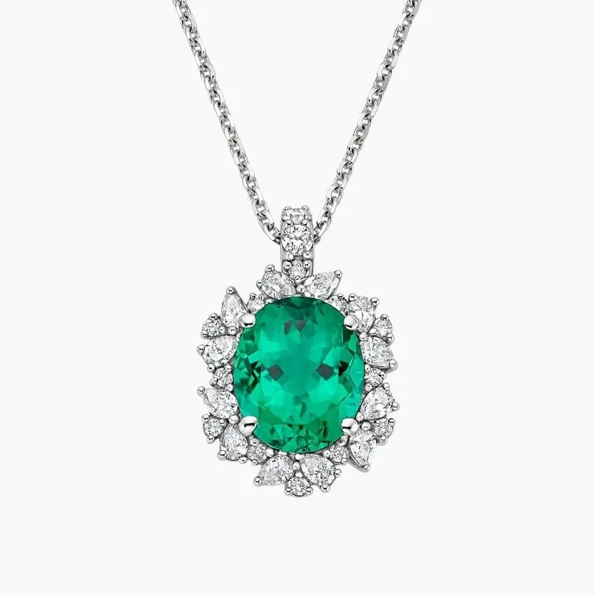 Oval emerald pendant surrounded by a halo of marquise and round diamonds